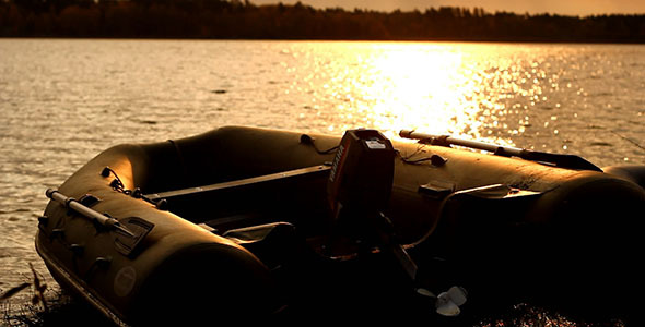 Rubber Motorboat On Lake Coast At Sunset Rubber Motorboat On Lake Coast At Sunset
