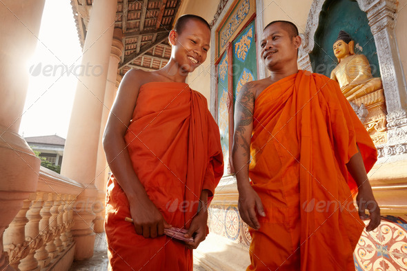 Two monks meet and salute in a buddhist monastery, Asia