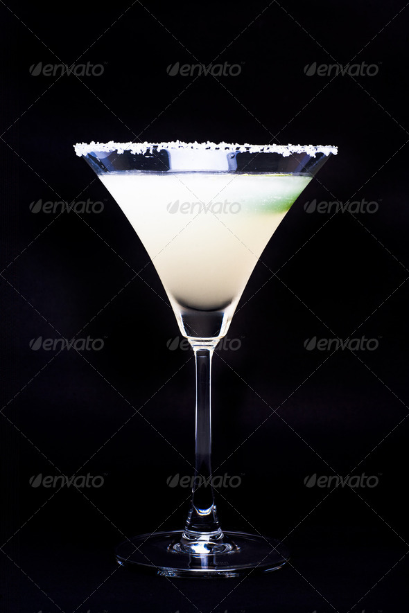 Margarita in glass with lime isolated on black background