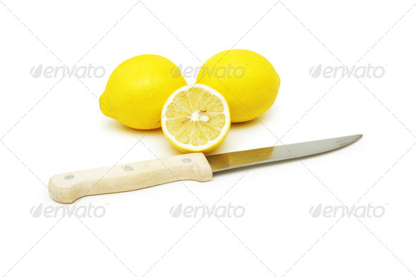 Lemons and knife isolated on white