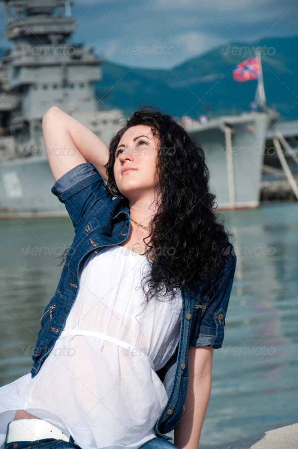 The woman on the background of a warship