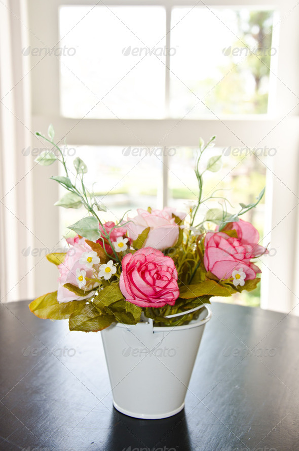 flower pot in front of a window.