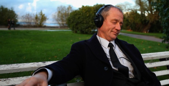 Senior Businessman Enjoying Music Outdoors Senior Businessman Enjoying Music Outdoors