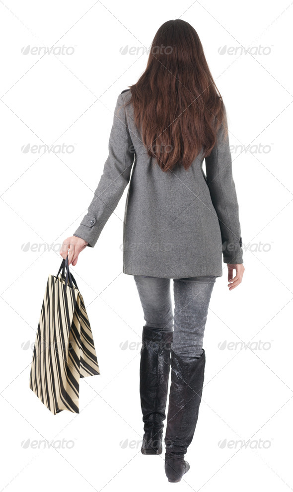 back view of going woman with shopping bags - Stock Photo - Images