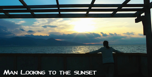 Man Looking To The Sunset Near The Seaside Man Looking To The Sunset Near The Seaside