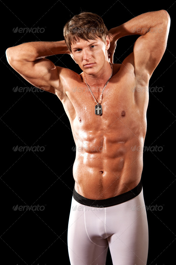 Male bodybuilder posing. Studio shot over black. - Stock Photo - Images