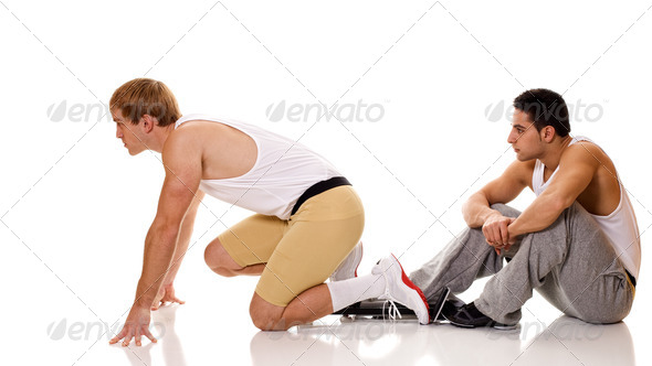 Track and field athlete at start of sprint. Studio shot over white. - Stock Photo - Images