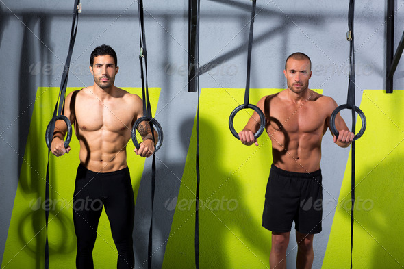Crossfit dip ring two men workout at gym - Stock Photo - Images