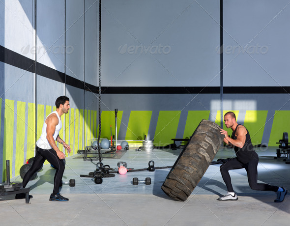 Crossfit flip tires men flipping each other - Stock Photo - Images