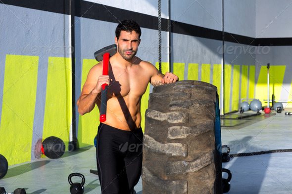 Crossfit sledge hammer man at gym relaxed - Stock Photo - Images
