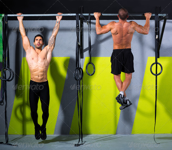 Crossfit toes to bar men pull-ups 2 bars workout - Stock Photo - Images