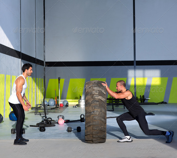Crossfit flip tires men flipping each other - Stock Photo - Images