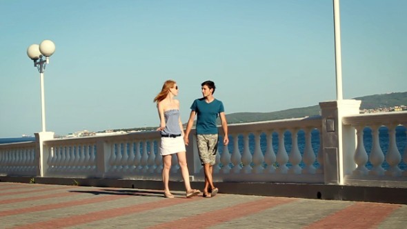 Couple Walking On the Embankment Couple Walking On the Embankment