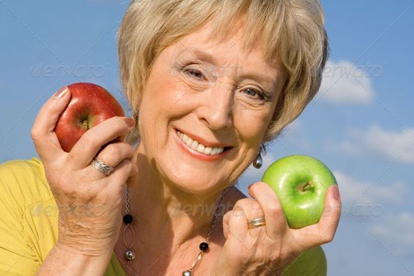 healthy senior woman with apples for health diet concept