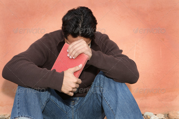 man holding, bible while praying