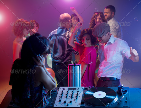 young couple dancing at party with female dj - Stock Photo - Images