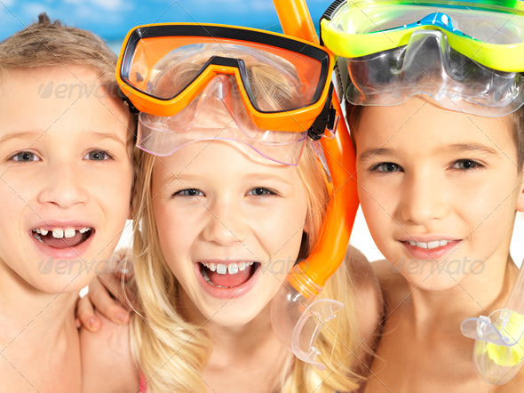 Portrait of the happy children enjoying at beach - Stock Photo - Images