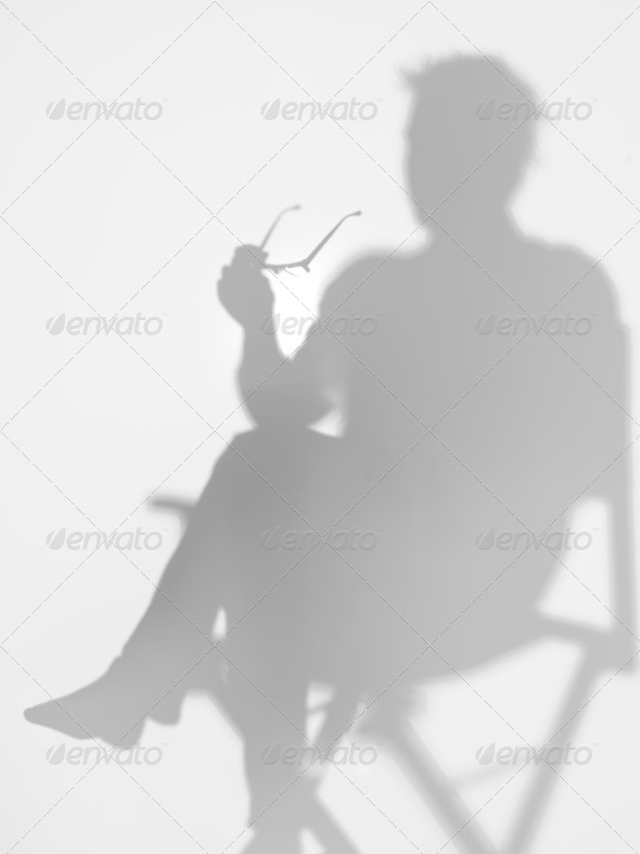 man sitting on director27;s chair, silhouette