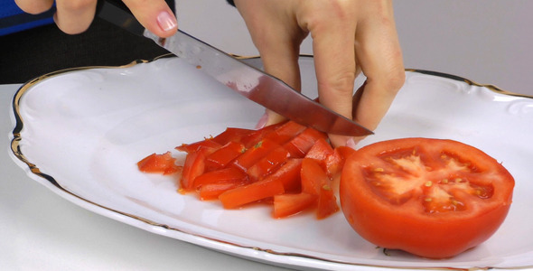 Female Hand Cutting Tomato Female Hand Cutting Tomato