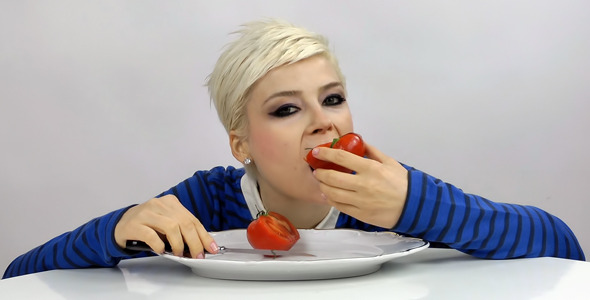 Woman Eating a Tomato Woman Eating a Tomato