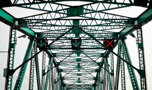Green steel bridge with traffic signal