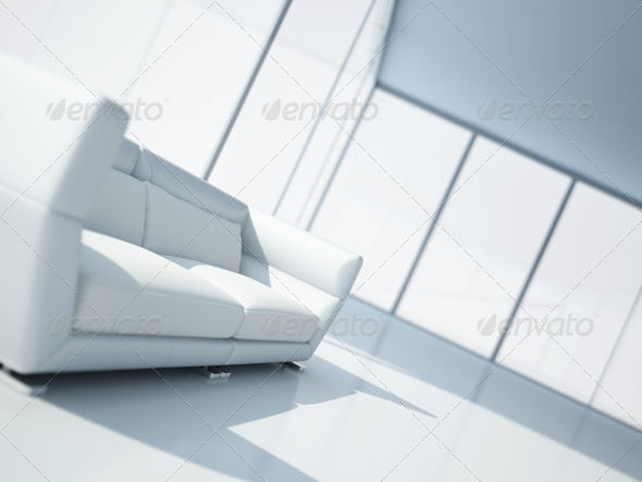 modern white leather sofa in a light interior with large windows