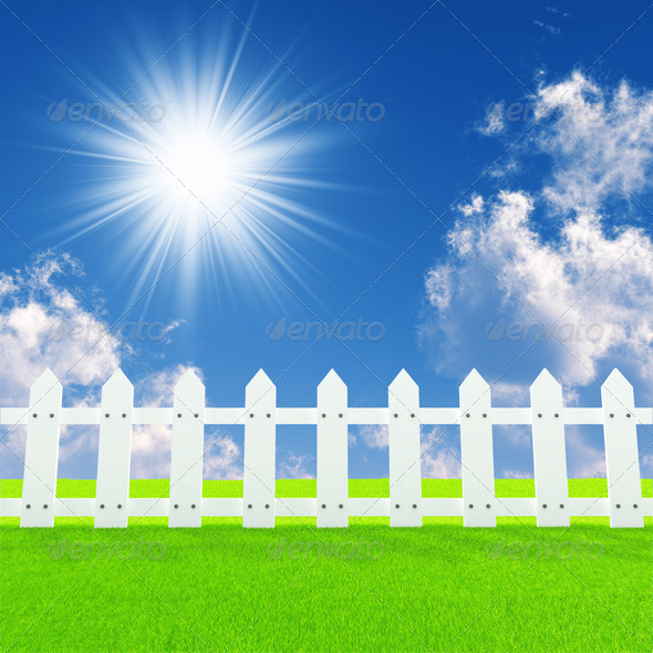 white fence on a summer lawn in a sun day