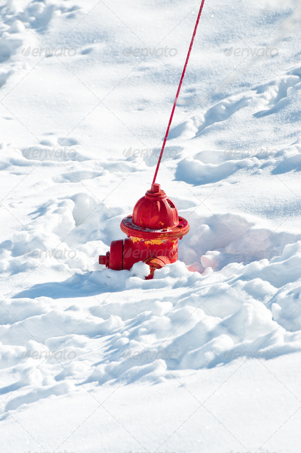 Red fire hydrant sunk in snow