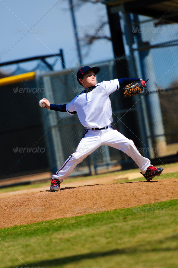 Little league pitcher in white jersey