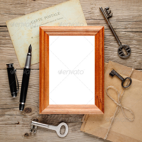 Old photo frame on wooden background