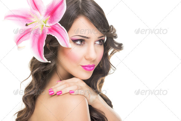 Beautiful face of young woman with pink lily flower - Stock Photo - Images