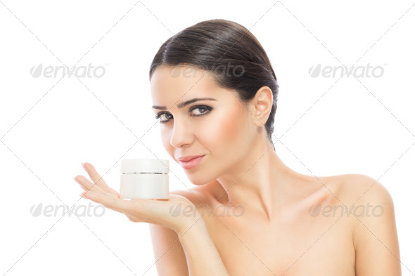 Gorgeous woman holding skin cream - Stock Photo - Images