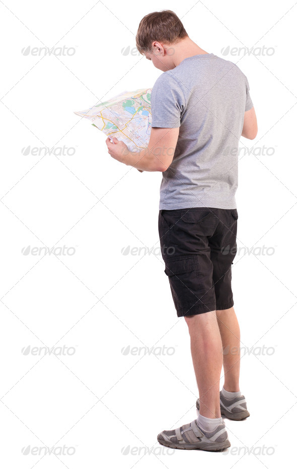 Back view of journey young man looking at the map - Stock Photo - Images