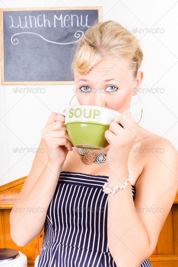 Pretty retro woman drinking hot cup of soup