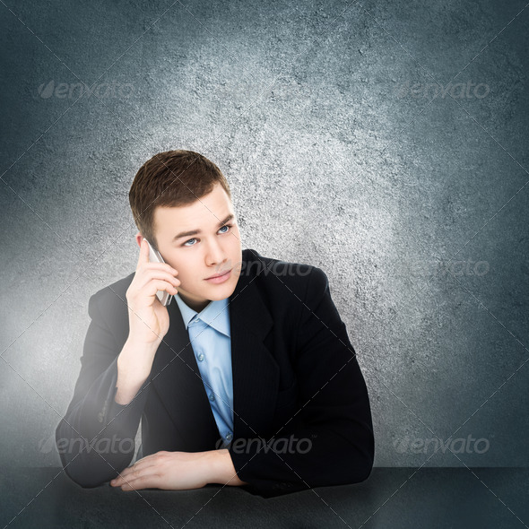 Modern young businessman talking on smartphone - Stock Photo - Images