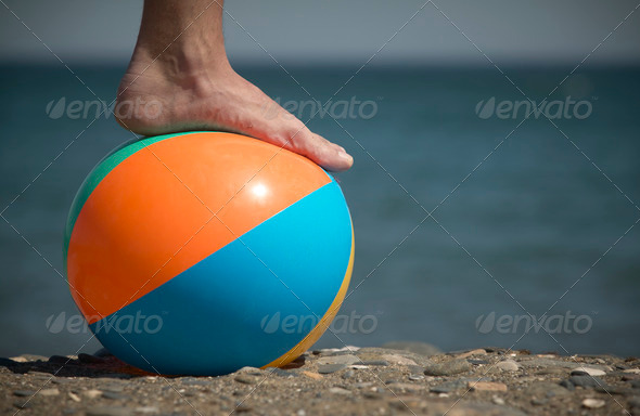 beach ball with foot and sand