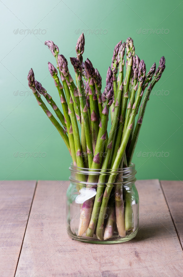 Fresh green asparagus in a glass jar