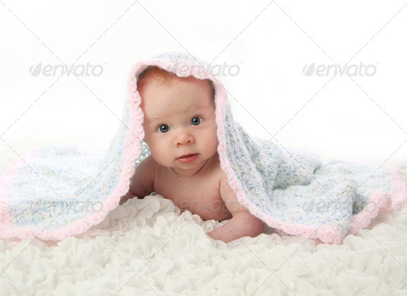 Baby lying on tummy under blanket
