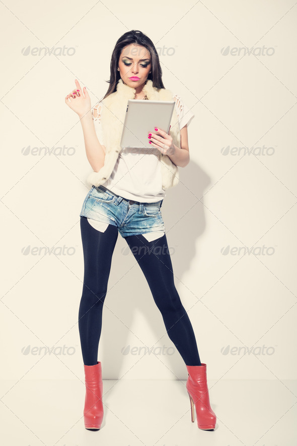 Attractive fashionable woman using digital tablet - Stock Photo - Images