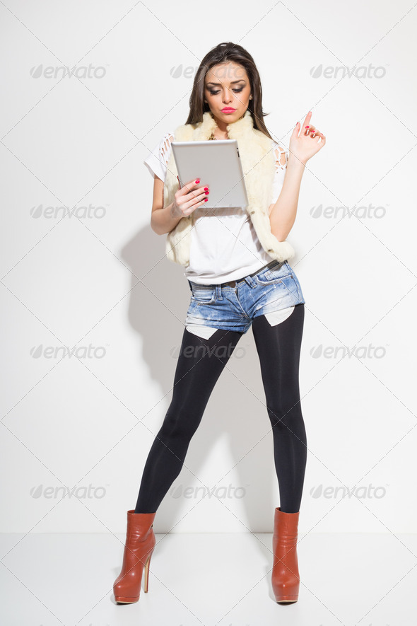Sexy fashionable young woman using digital tablet - Stock Photo - Images