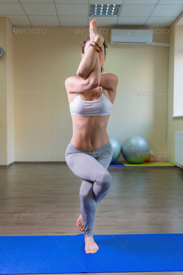 Young woman standing in yoga asana