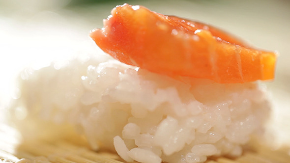 Putting Piece Of Salmon On Sushi Rice Putting Piece Of Salmon On Sushi Rice