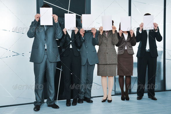Successful business team standing holding white papers