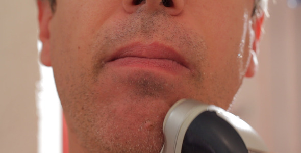 Man Shaving With Electric Razor Man Shaving With Electric Razor
