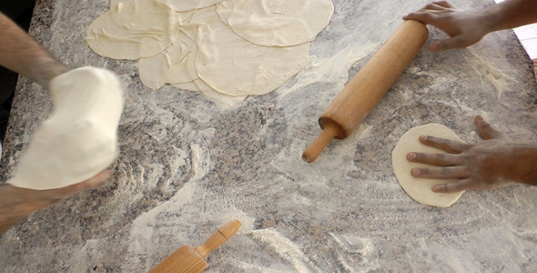Baker Making Pitas With Roller Baker Making Pitas With Roller