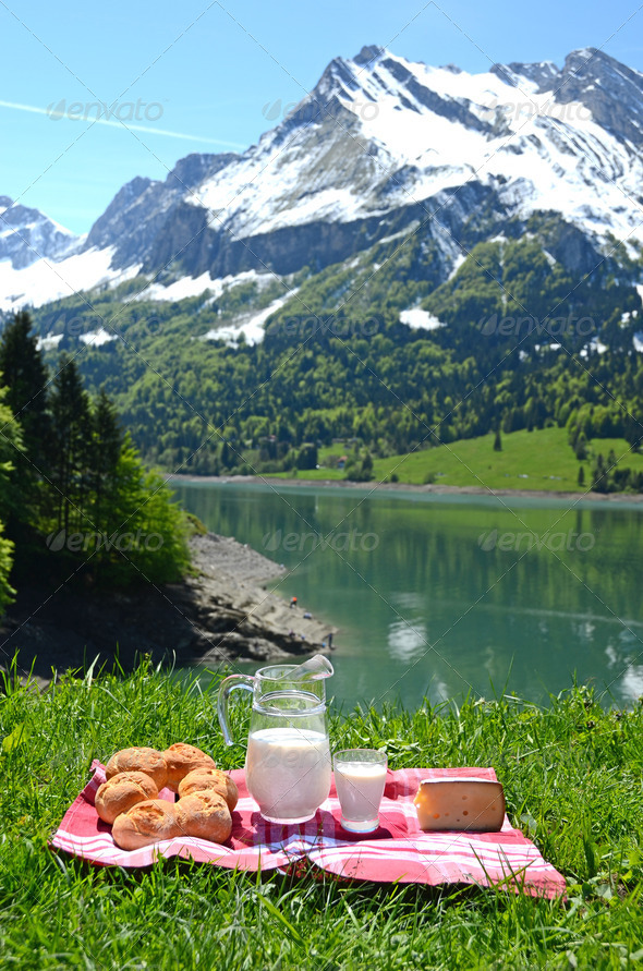Milk, cheese and bread served at a picnic in an Alpine meadow, S