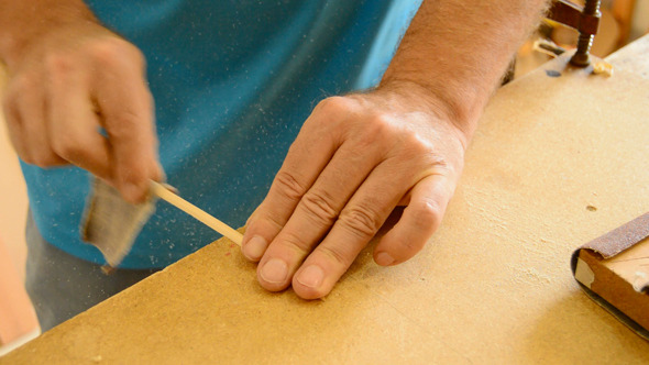 Luthier Sanding a Guitar Piece Luthier Sanding a Guitar Piece