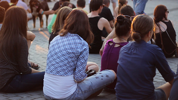 Girls Audience Sitting on Pavement Girls Audience Sitting on Pavement