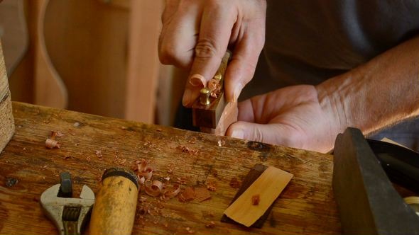 Luthier Sanding a Guitar Piece Luthier Sanding a Guitar Piece