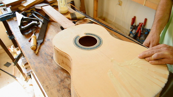 Luthier Decorating a Guitar Luthier Decorating a Guitar
